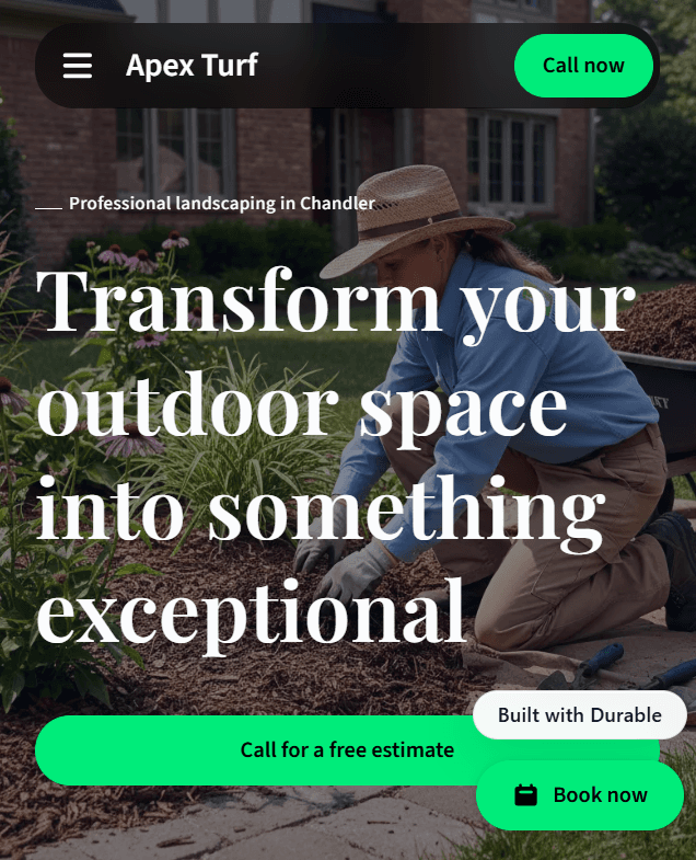 Professional landscaper in a straw hat tending to a garden bed with mulch and flowers.